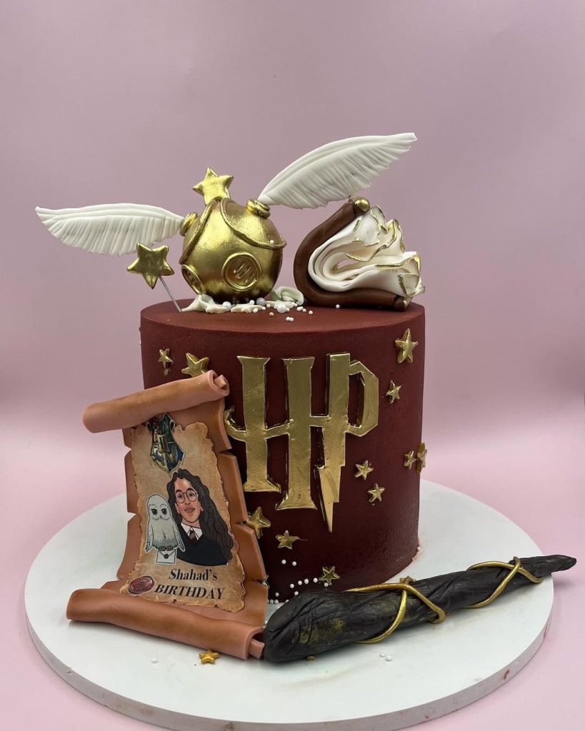Gorgeous Burgundy Harry Potter Theme Birthday Cake with stunning golden fondant stars and golden snitch ball